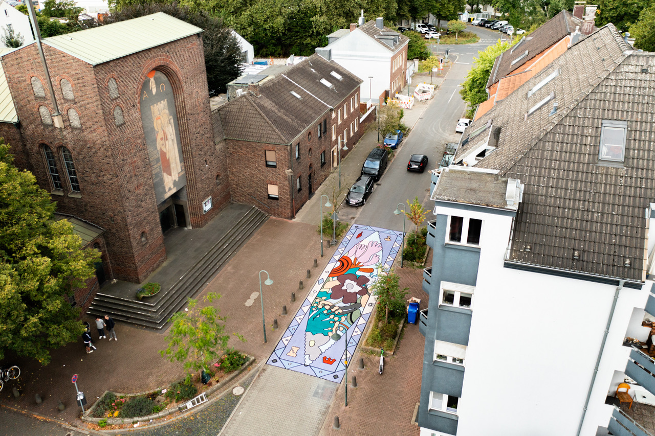 Luftaufnahme Straßenmalerei: mehrfarbiges Mosaik als Fußgängerübergang
